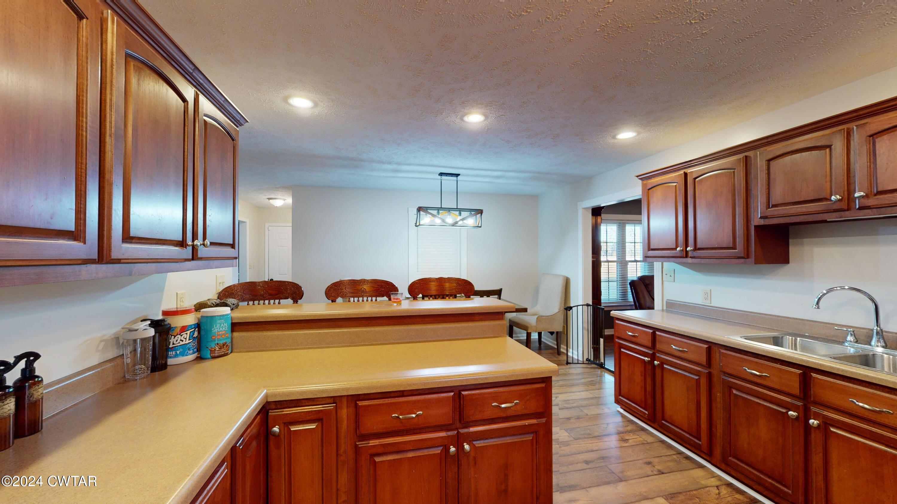 3999 Cloverdale Road Obion, TN 38240 - Photo 11 of 42 a kitchen with stainless steel appliances granite countertop a sink a stove and a refrigerator