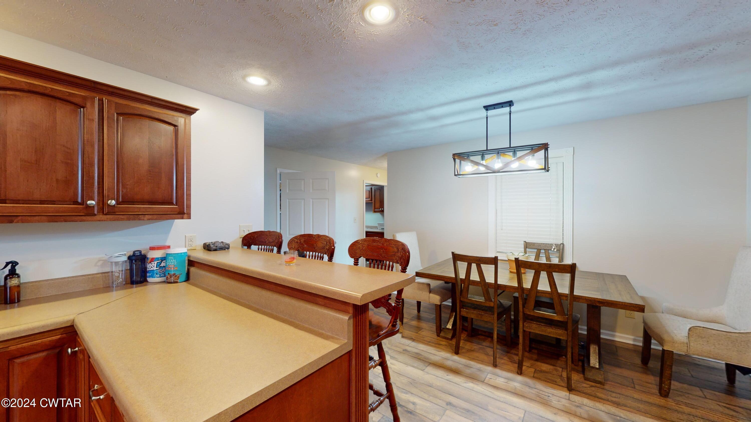 3999 Cloverdale Road Obion, TN 38240 - Photo 15 of 42 a kitchen with a table chairs and a refrigerator