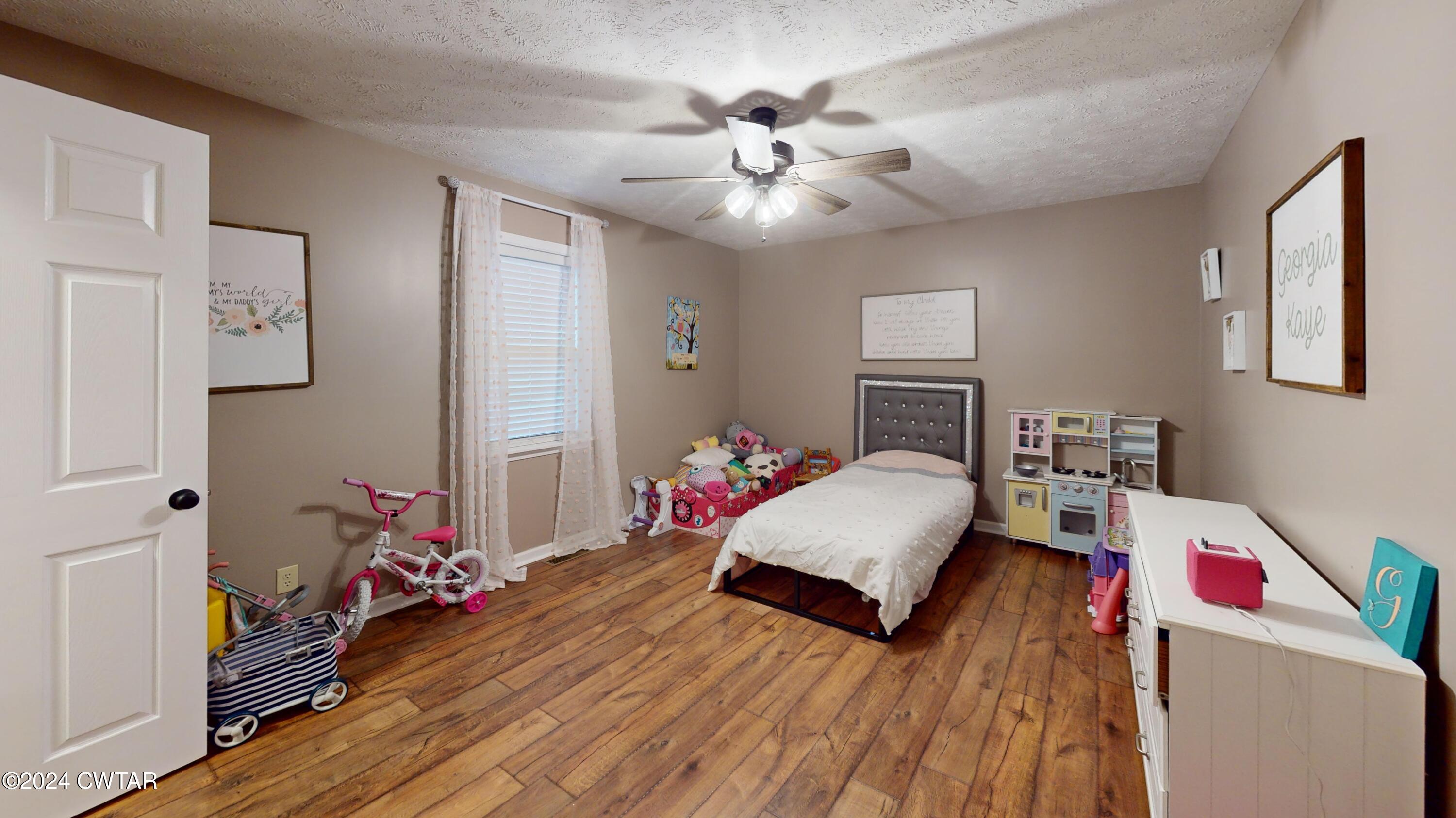 3999 Cloverdale Road Obion, TN 38240 - Photo 28 of 42 a bedroom with bed and a chandelier