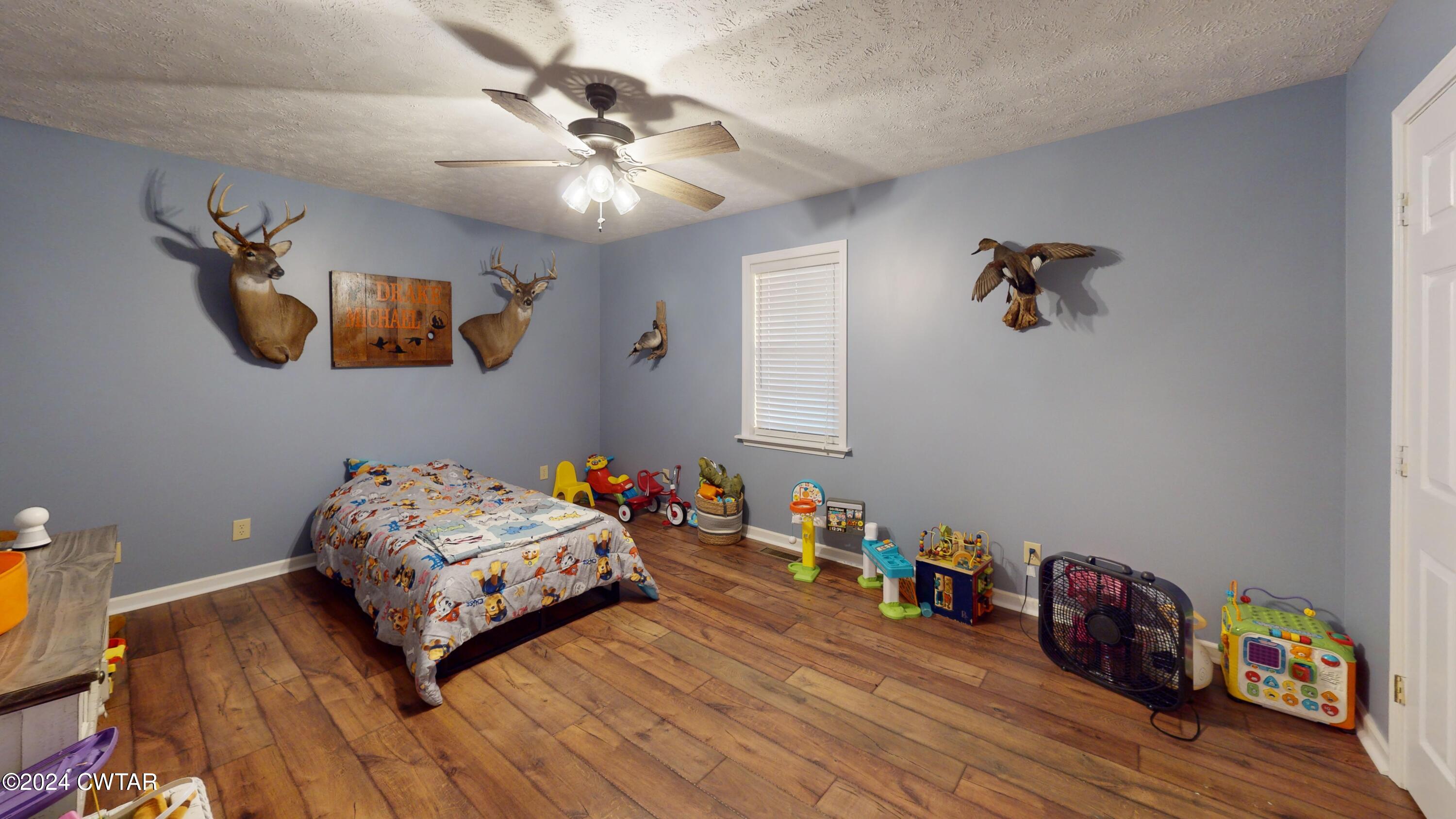 3999 Cloverdale Road Obion, TN 38240 - Photo 34 of 42 a bedroom with a bed and wooden floor