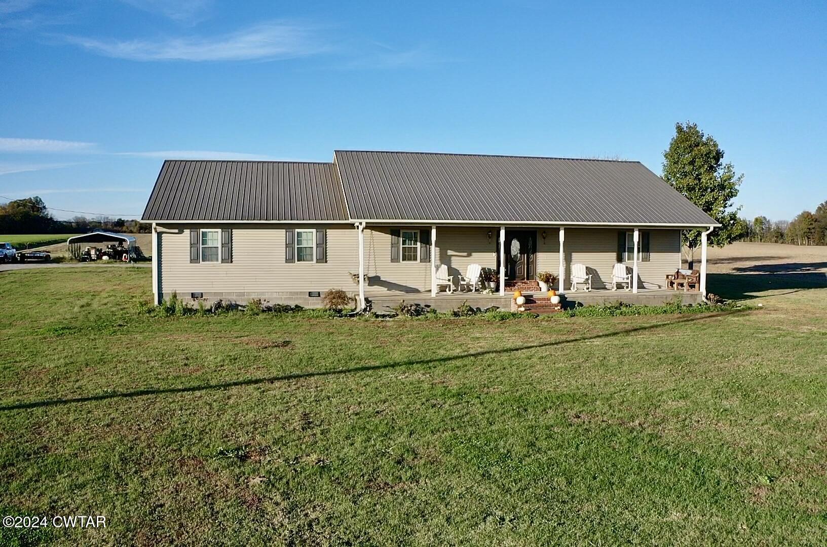 3999 Cloverdale Road Obion, TN 38240 - Photo 39 of 42 a front view of a house with a yard table and chairs