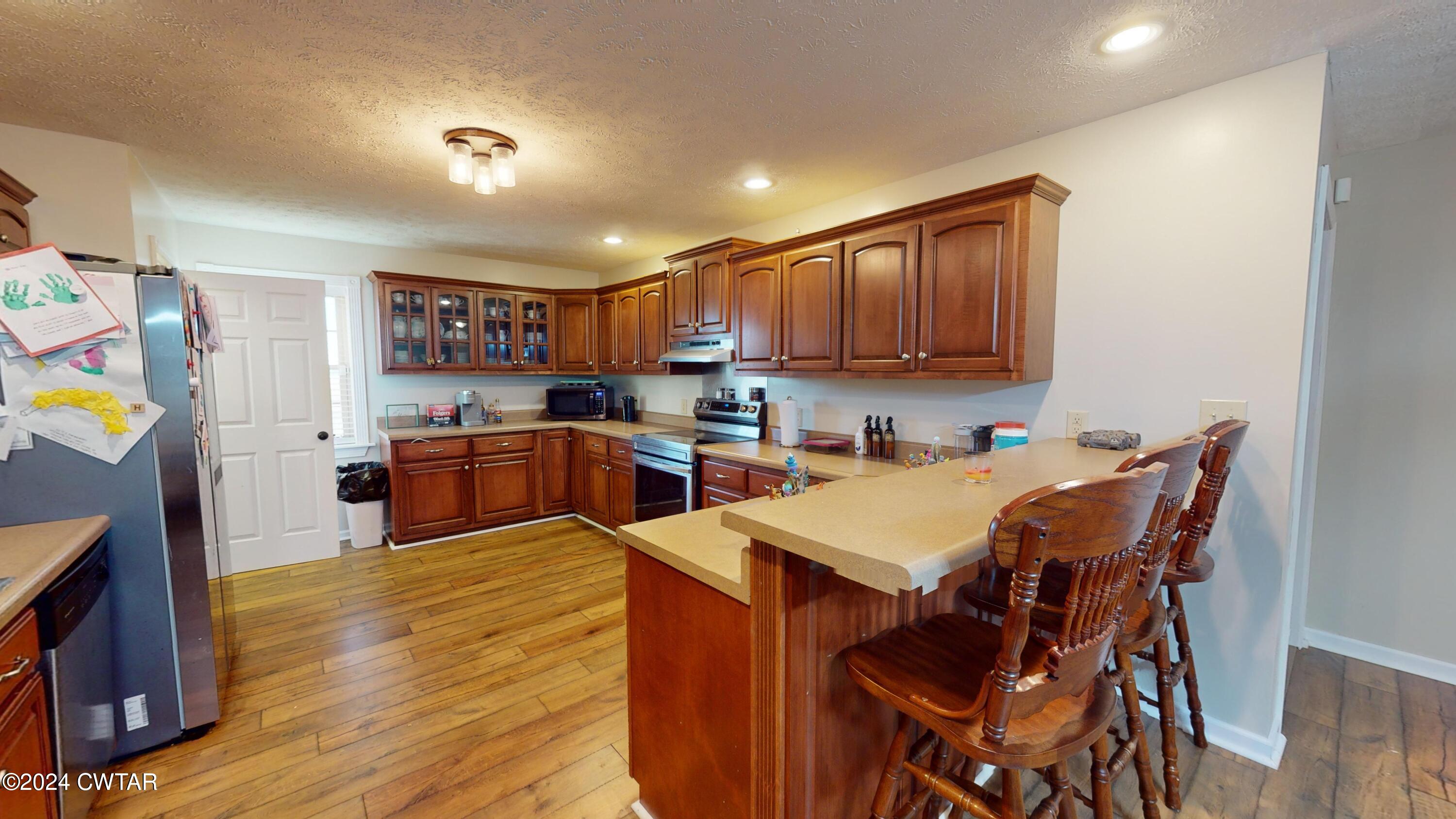 3999 Cloverdale Road Obion, TN 38240 - Photo 7 of 42 a open kitchen with a table and chairs in it