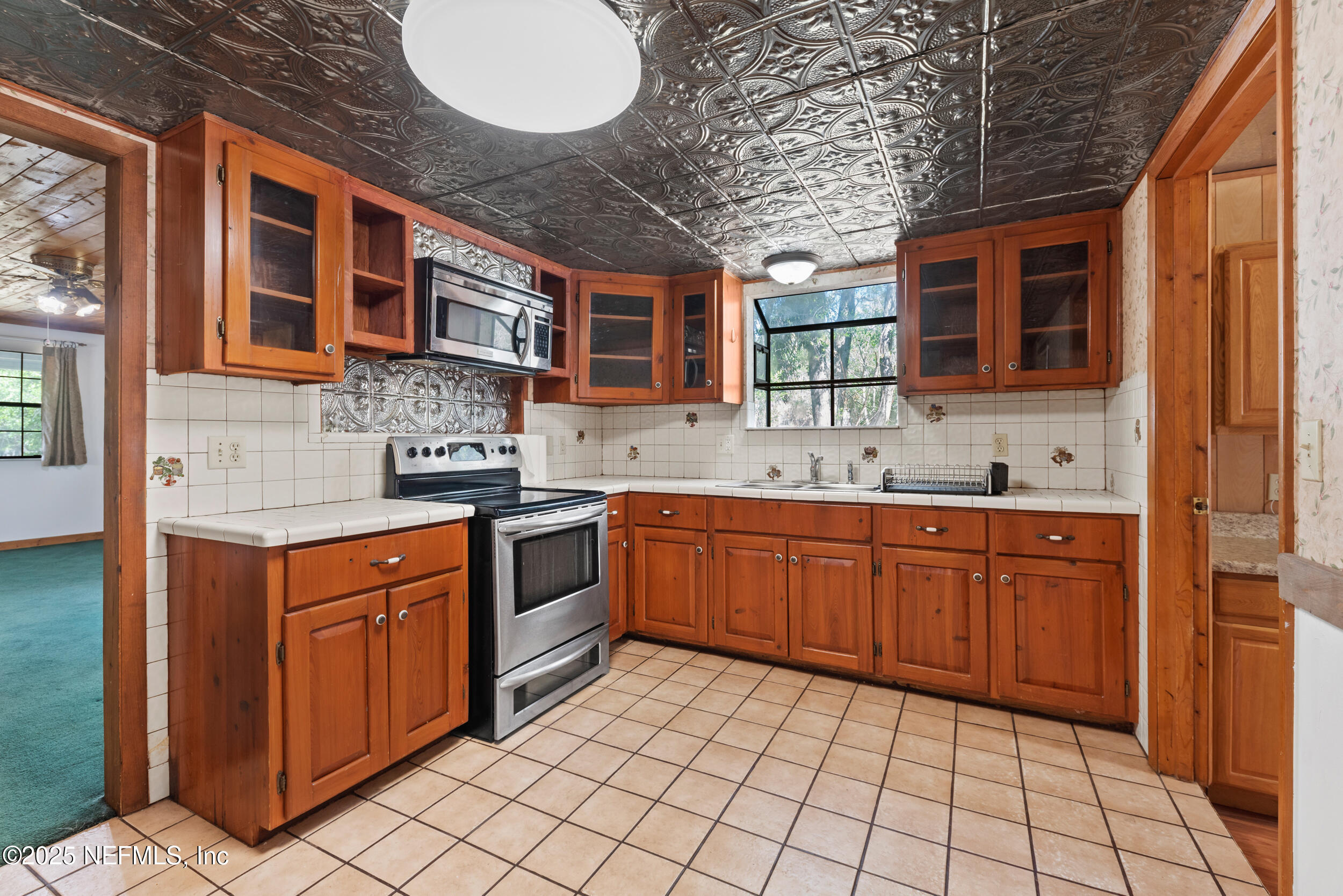 2357 Davis Road Jacksonville, FL 32218 - Photo 11 of 28 a kitchen with stainless steel appliances granite countertop a sink and cabinets