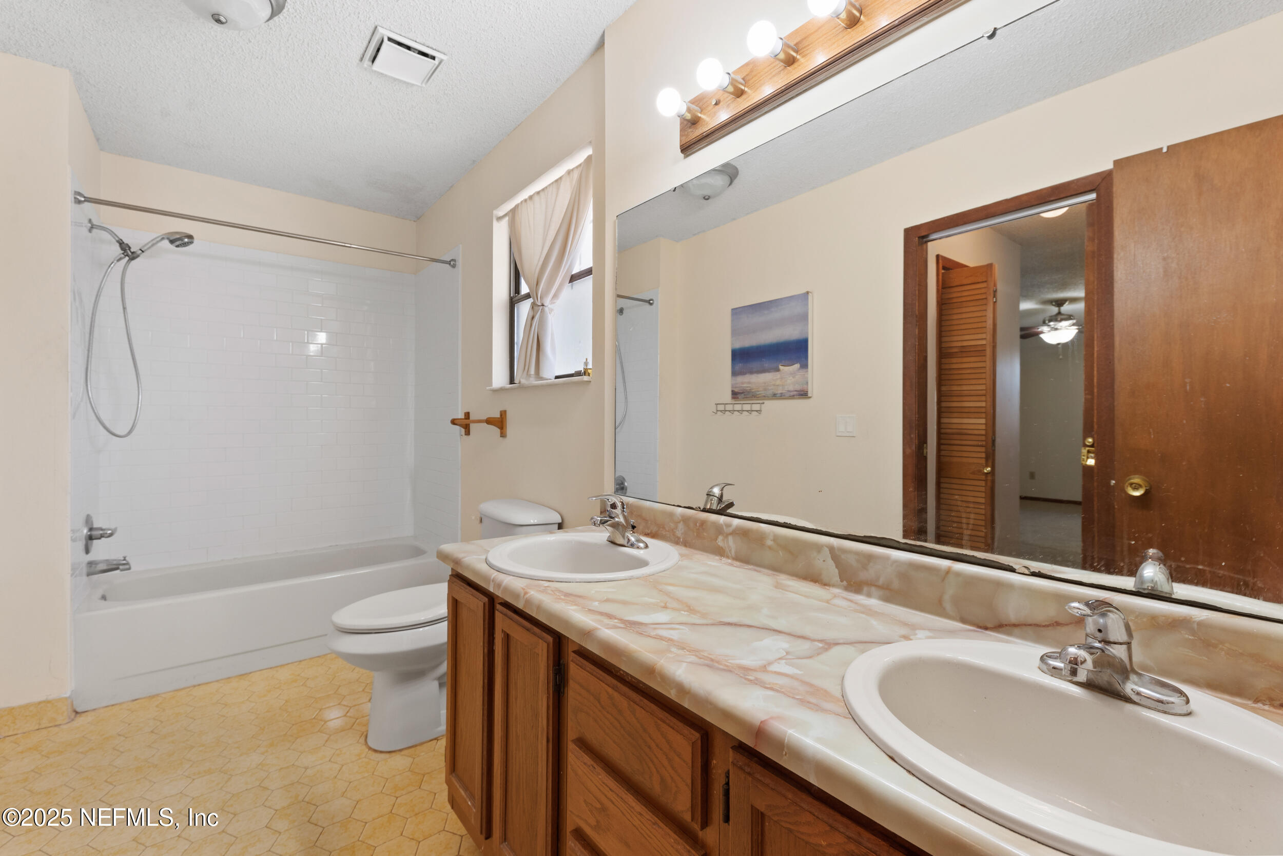 2357 Davis Road Jacksonville, FL 32218 - Photo 17 of 28 a bathroom with a granite countertop sink toilet and shower