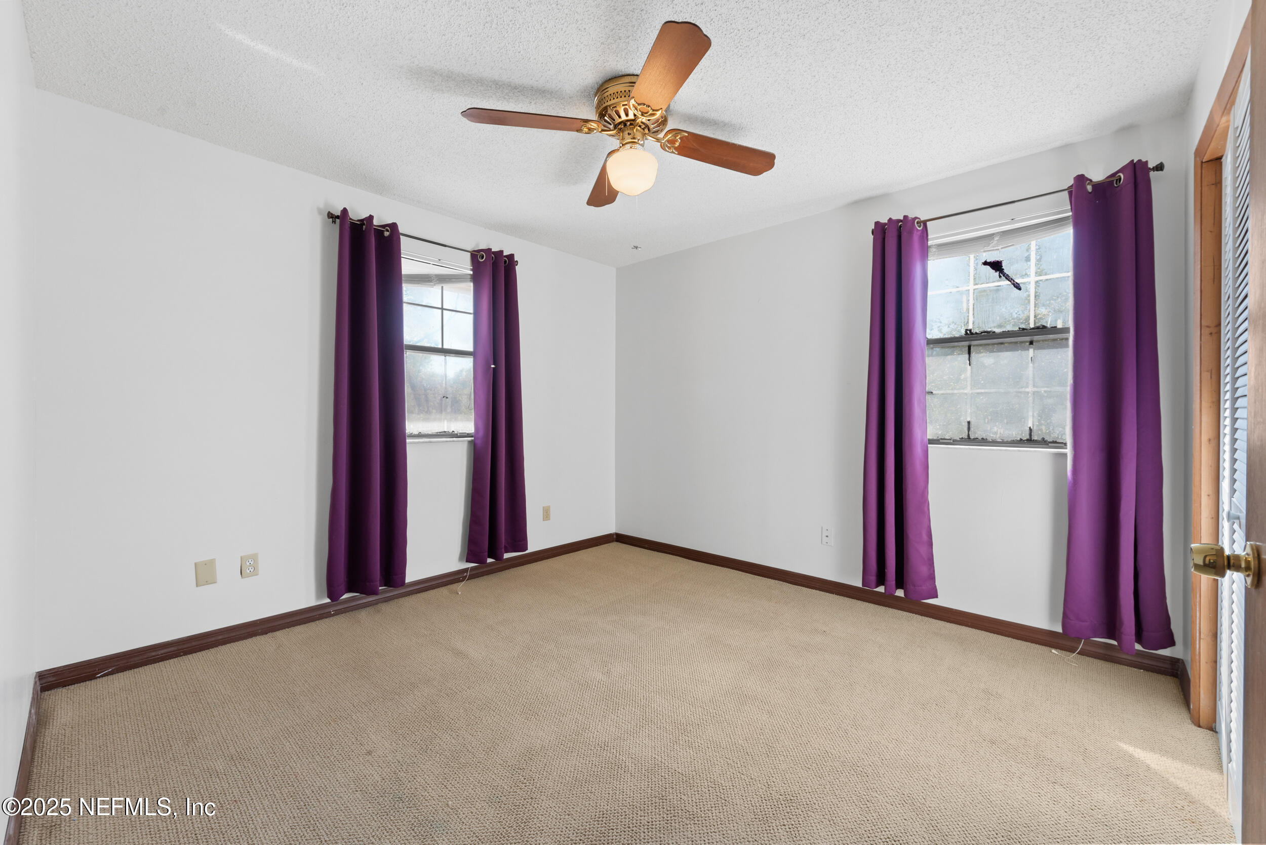 2357 Davis Road Jacksonville, FL 32218 - Photo 20 of 28 an empty room with windows and fan