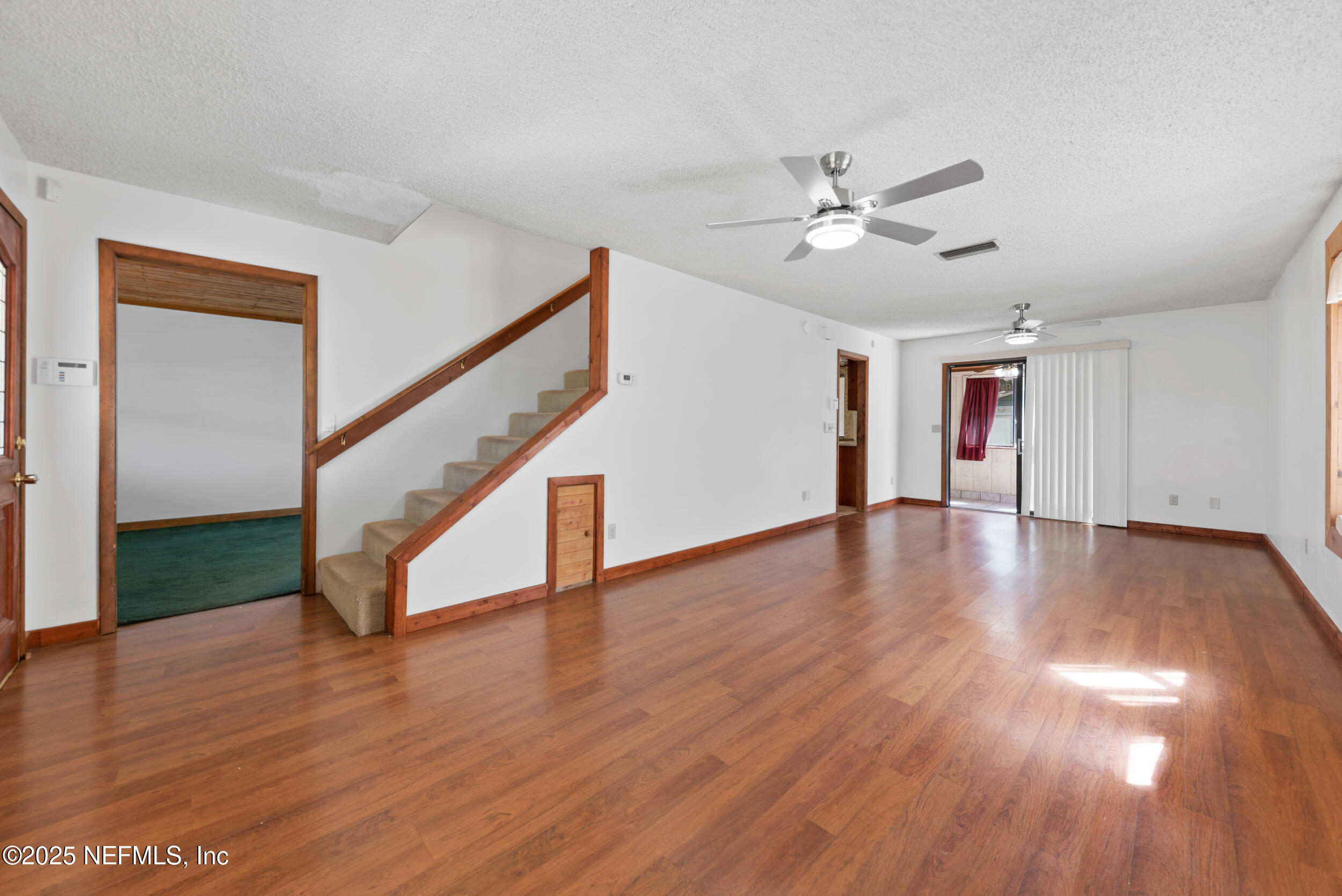 2357 Davis Road Jacksonville, FL 32218 - Photo 5 of 28 a view of empty room with wooden floor and fan