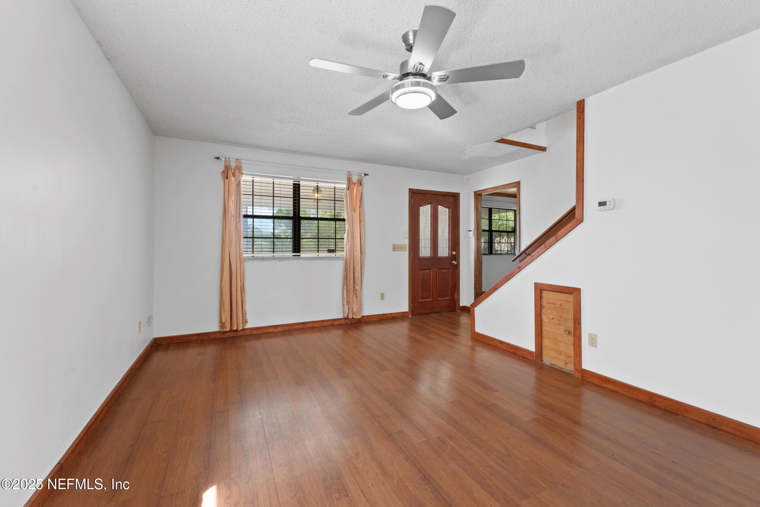 2357 Davis Road Jacksonville, FL 32218 - Photo 6 of 28 an empty room with wooden floor and windows