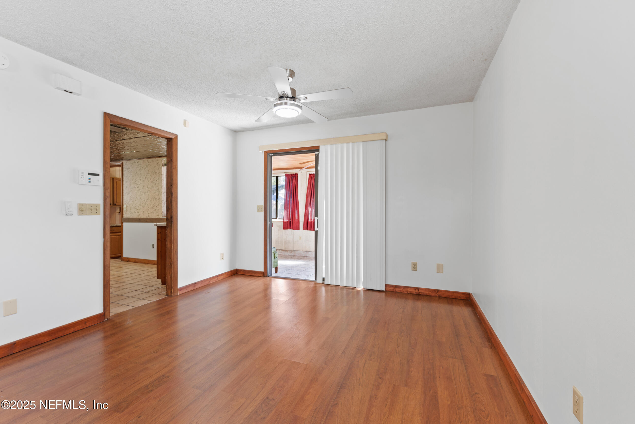 2357 Davis Road Jacksonville, FL 32218 - Photo 7 of 28 an empty room with wooden floor and windows