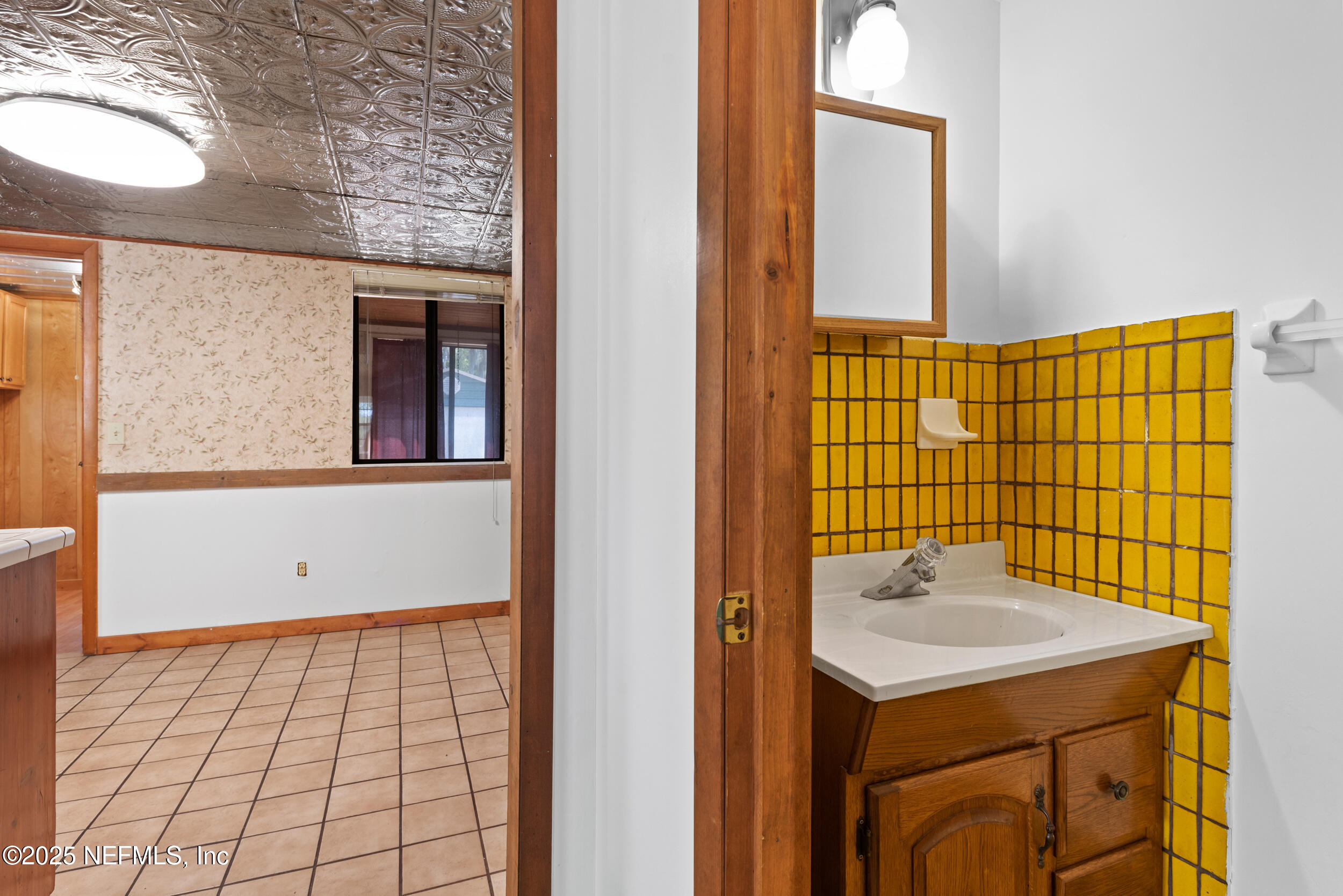 2357 Davis Road Jacksonville, FL 32218 - Photo 10 of 28 a bathroom with a sink and mirror