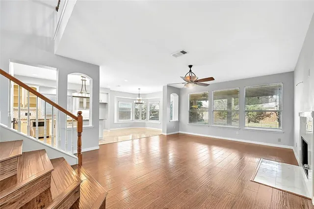 a front view of a house with a yard and trees