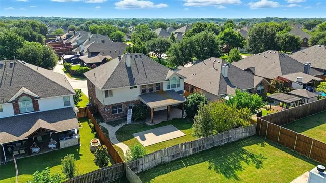 an aerial view of multiple houses with yard