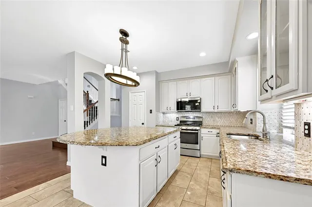 a view of wooden floor fire place and windows in a room