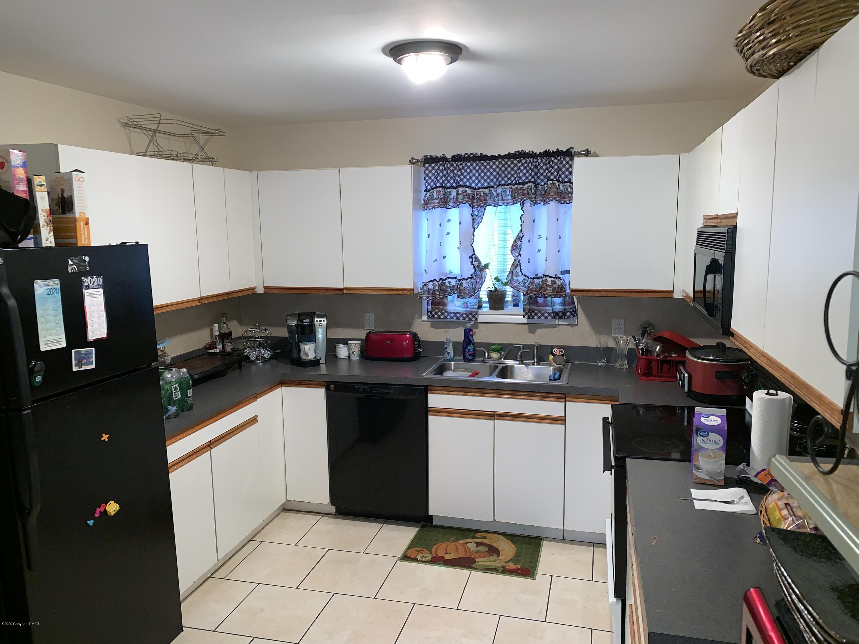 6441 Decker Road Bushkill, PA 18324 - Photo 8 of 19 a kitchen with a sink cabinets and window