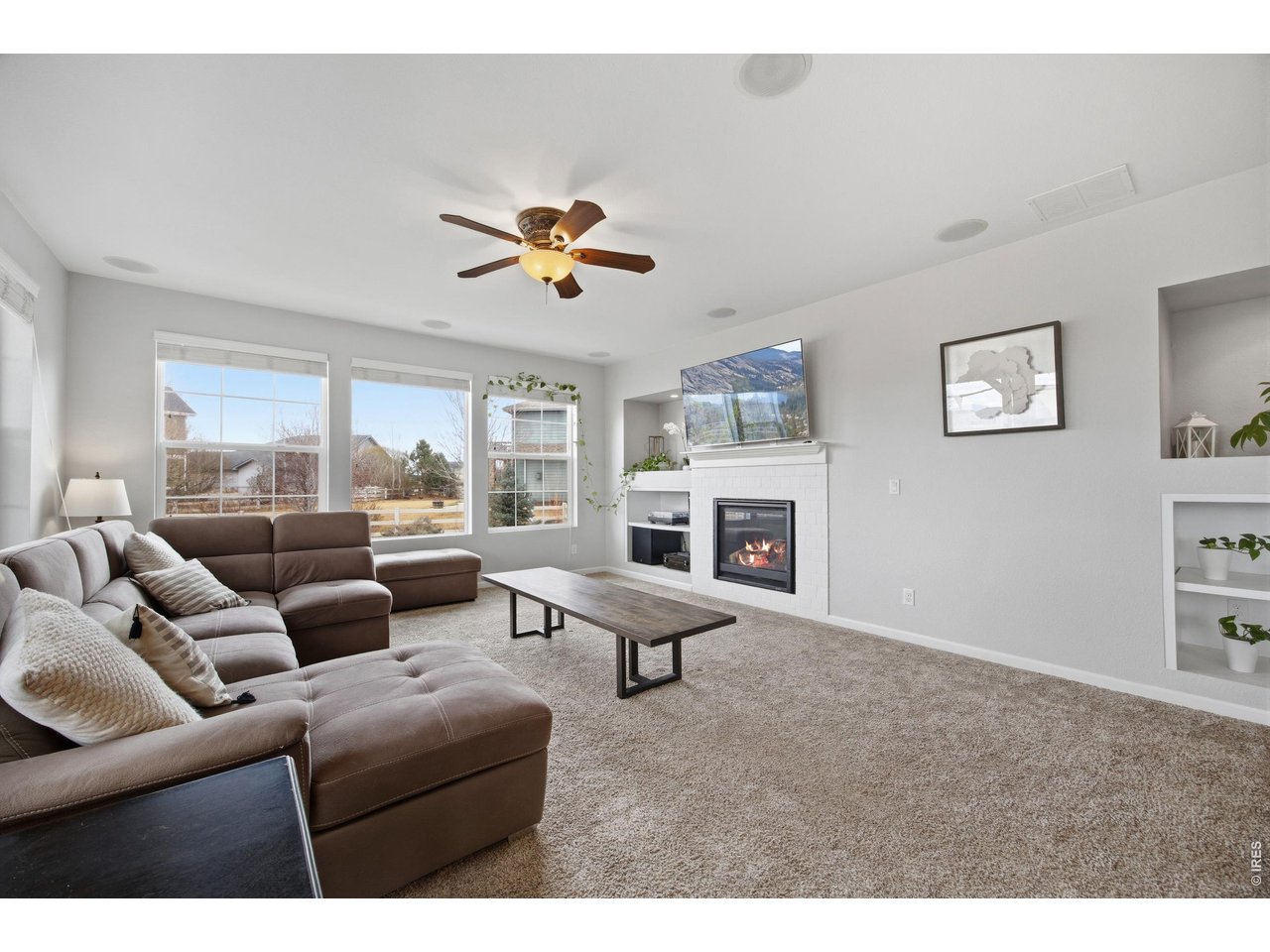 9033 Foxfire Street Firestone, CO 80504 - Photo 17 of 44 a living room with furniture ceiling fan and a window
