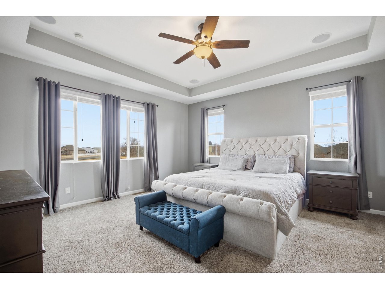 9033 Foxfire Street Firestone, CO 80504 - Photo 23 of 44 a bedroom with a bed a window and a chandelier