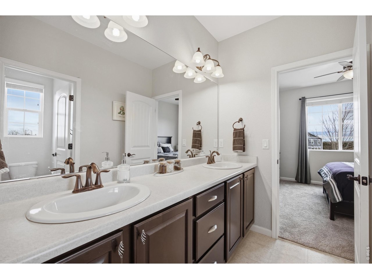9033 Foxfire Street Firestone, CO 80504 - Photo 27 of 44 a bathroom with a sink a double vanity and a mirror