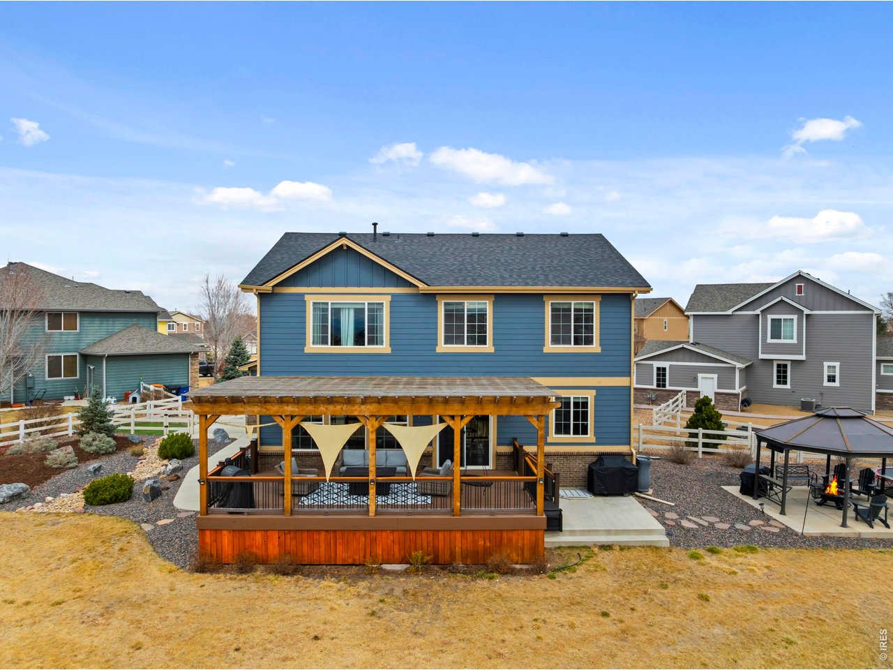 9033 Foxfire Street Firestone, CO 80504 - Photo 32 of 44 a front view of a house with large trees