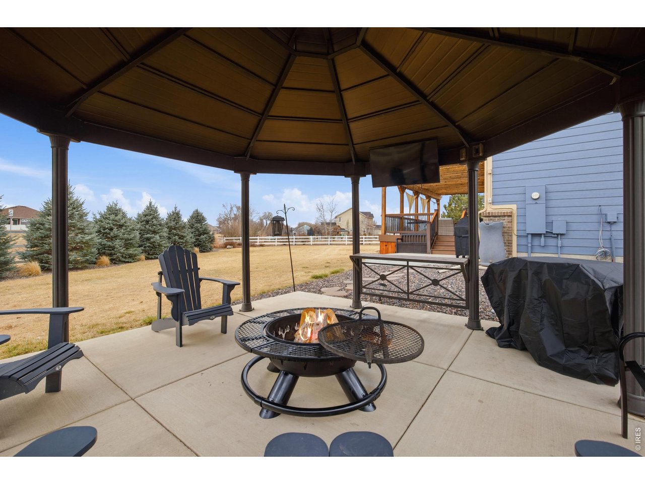 9033 Foxfire Street Firestone, CO 80504 - Photo 36 of 44 a view of a swimming pool with a couches in a patio