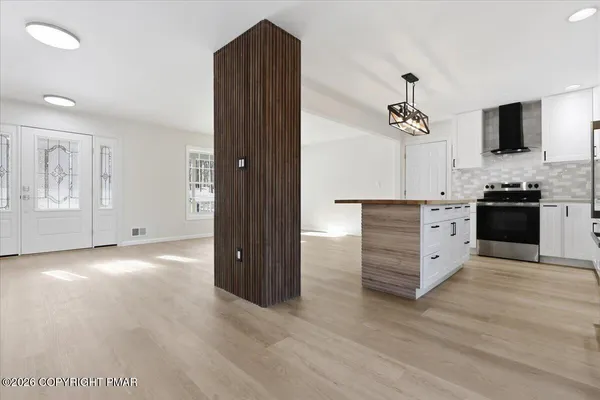 a kitchen with stainless steel appliances granite countertop a stove a sink and a refrigerator