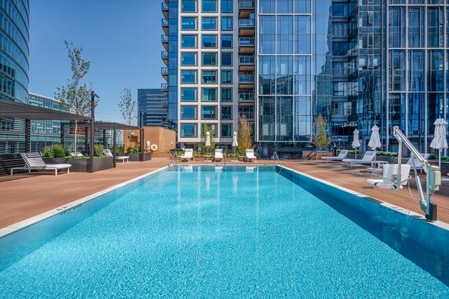 a swimming pool with outdoor seating and yard