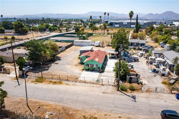 an aerial view of a house with a yard and parking spaces