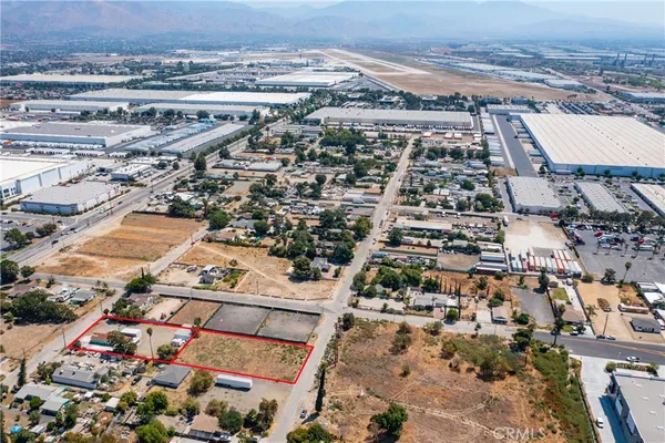 an aerial view of a house with a yard and parking spaces