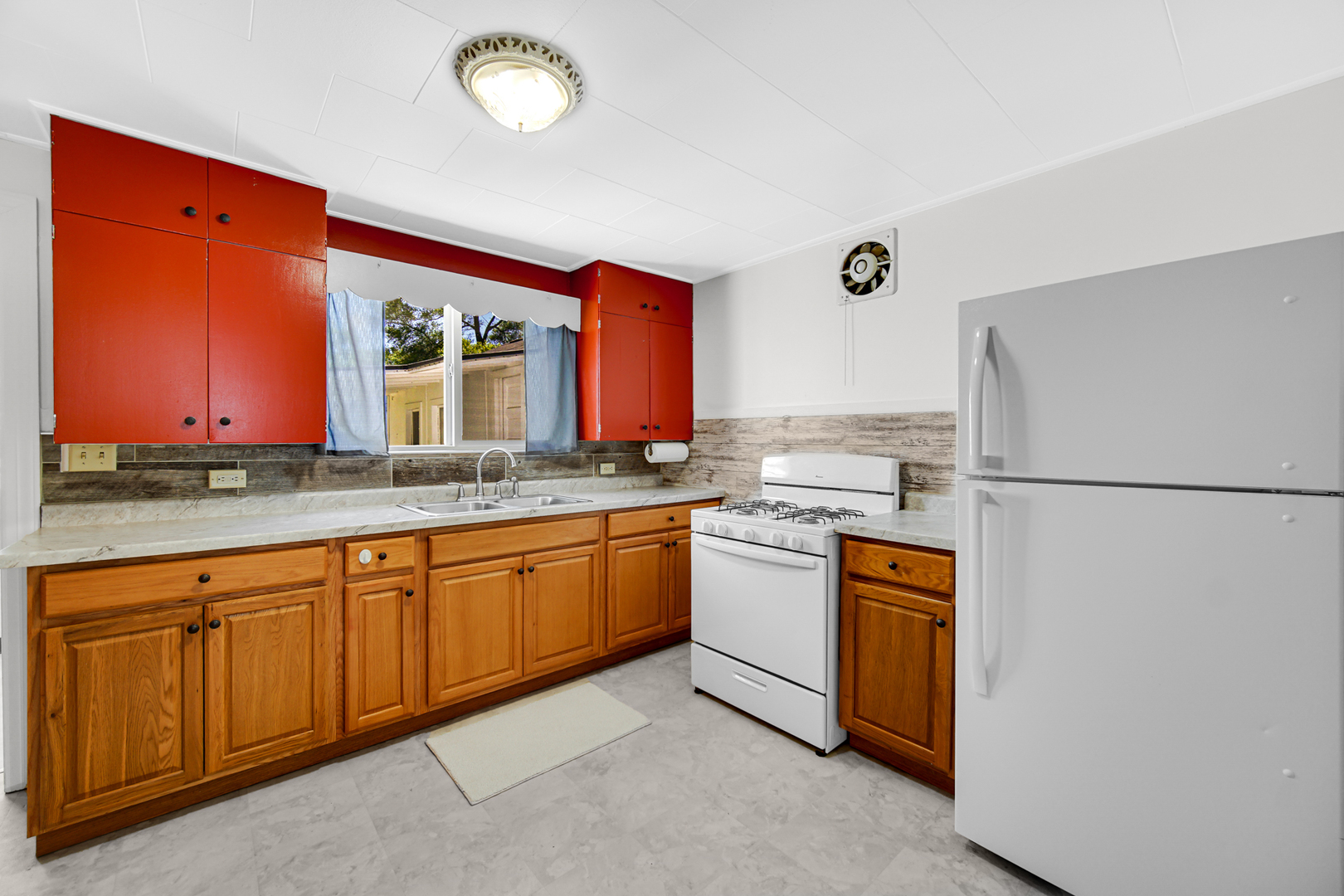 5201 Bell Avenue Portage, IN 46368 - Photo 12 of 16 a kitchen with granite countertop stainless steel appliances a refrigerator a sink and a counter space