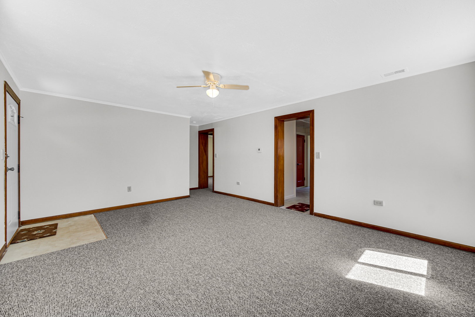5201 Bell Avenue Portage, IN 46368 - Photo 4 of 16 an empty room with a ceiling fan and window