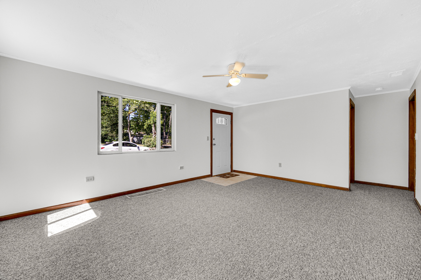 5201 Bell Avenue Portage, IN 46368 - Photo 5 of 16 an empty room with windows and chandelier fan
