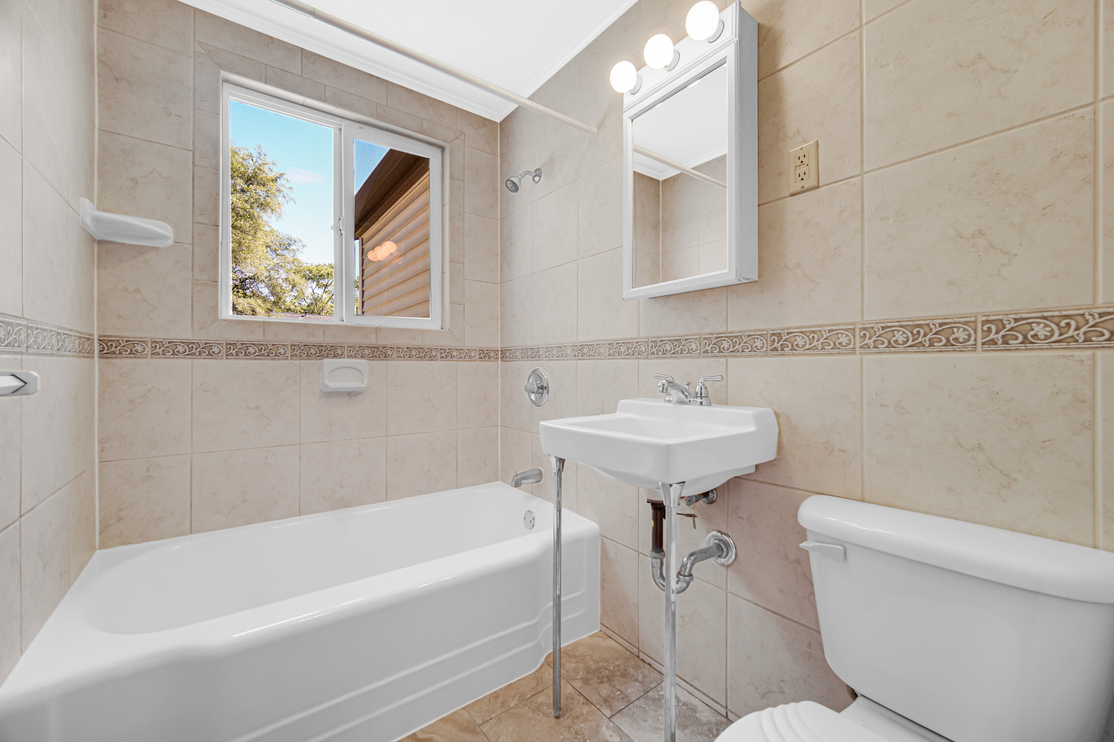 5201 Bell Avenue Portage, IN 46368 - Photo 9 of 16 a bathroom with a sink a mirror a toilet and a bathtub