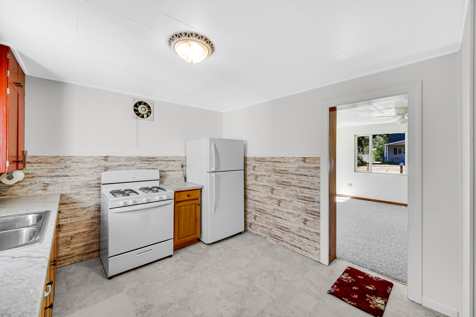 5201 Bell Avenue Portage, IN 46368 - Photo 10 of 16 a kitchen with white cabinets and white appliances