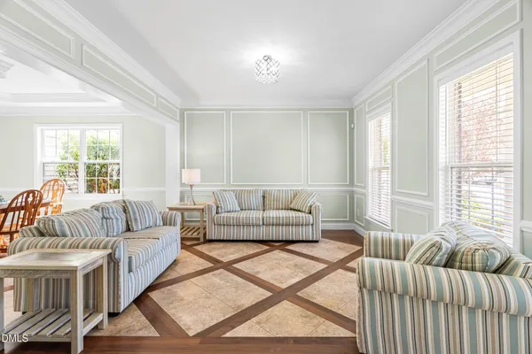 a living room with furniture and a chandelier