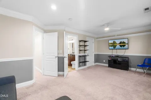 a spacious bedroom with a bed and a chandelier