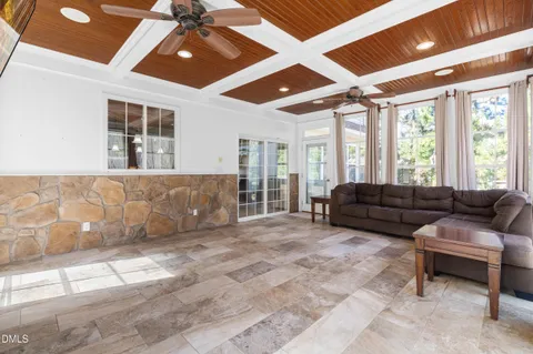 a living room with furniture and large windows