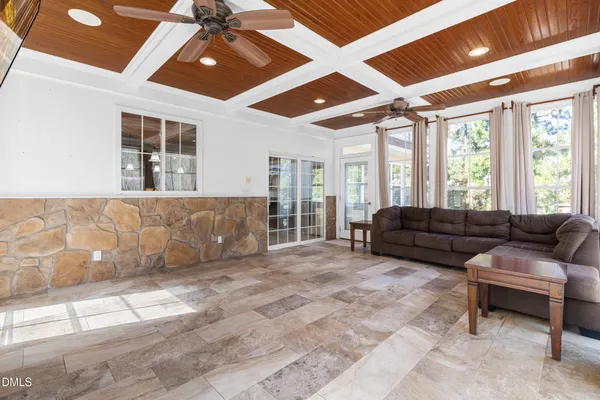 a living room with furniture and large windows