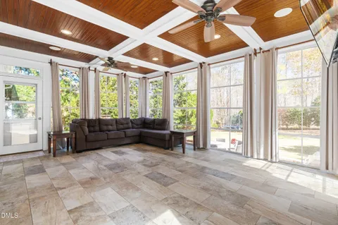 a view of a house with swimming pool and sitting area