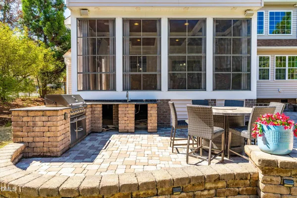 a view of a house with swimming pool and sitting area