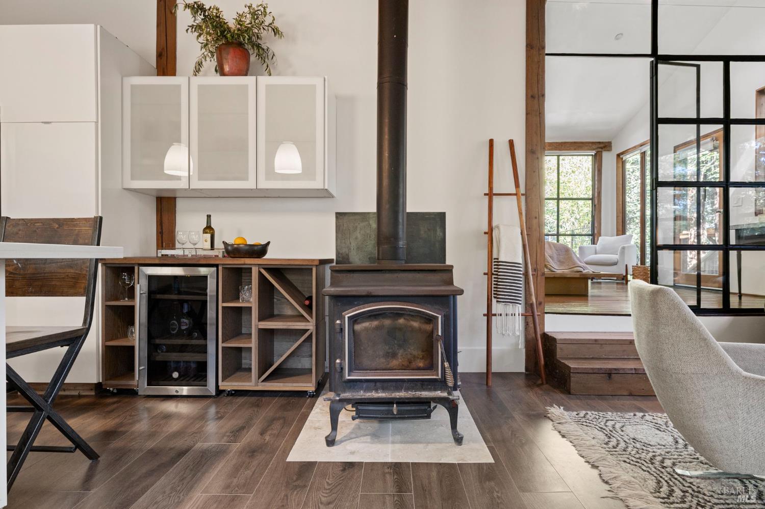 16798 Armstrong Woods Road Guerneville, CA 95446 - Photo 20 of 71 a living room with furniture a fireplace and a floor to ceiling window