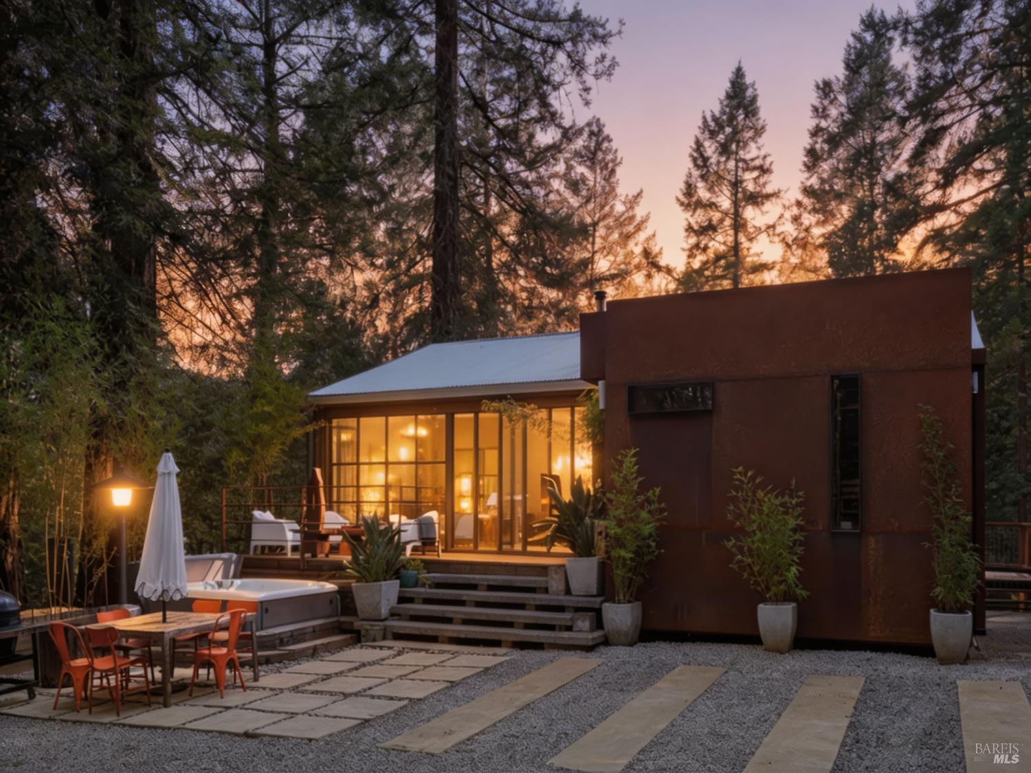 16798 Armstrong Woods Road Guerneville, CA 95446 - Photo 2 of 71 a view of a patio with table and chairs with wooden fence and plants
