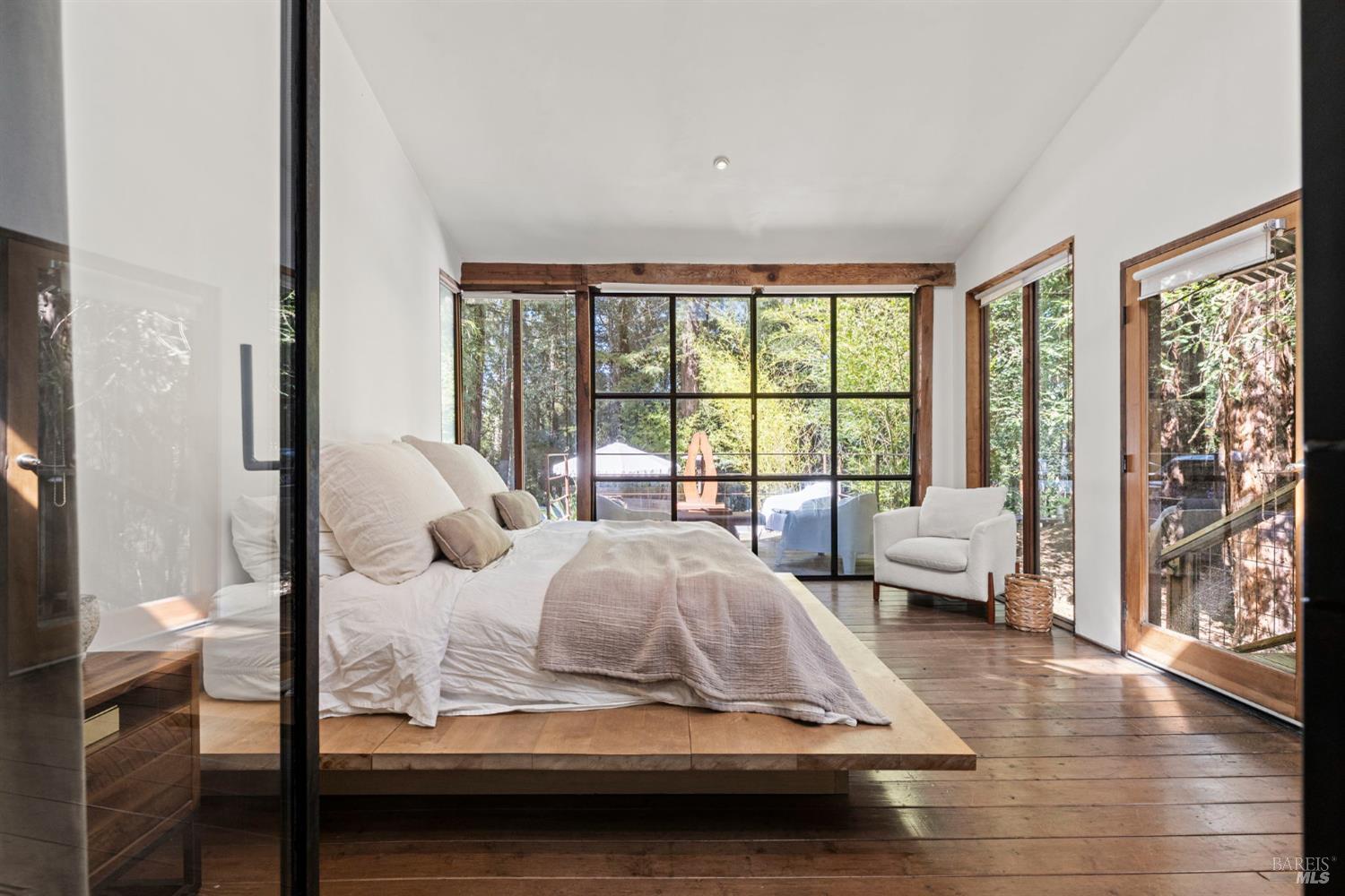 16798 Armstrong Woods Road Guerneville, CA 95446 - Photo 23 of 71 a living room with furniture and a large window with outer view