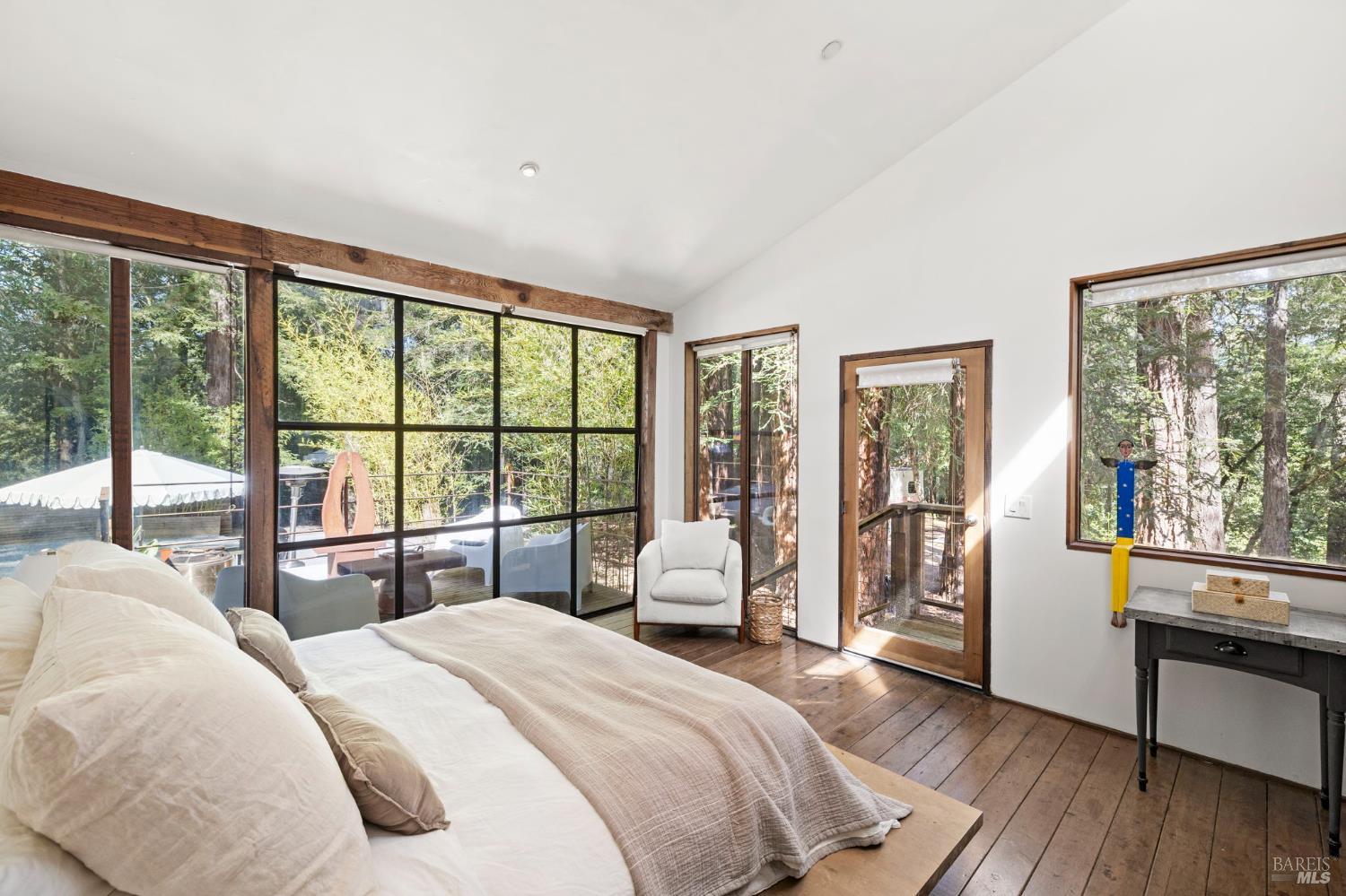 16798 Armstrong Woods Road Guerneville, CA 95446 - Photo 25 of 71 a bedroom with a large bed and a large window