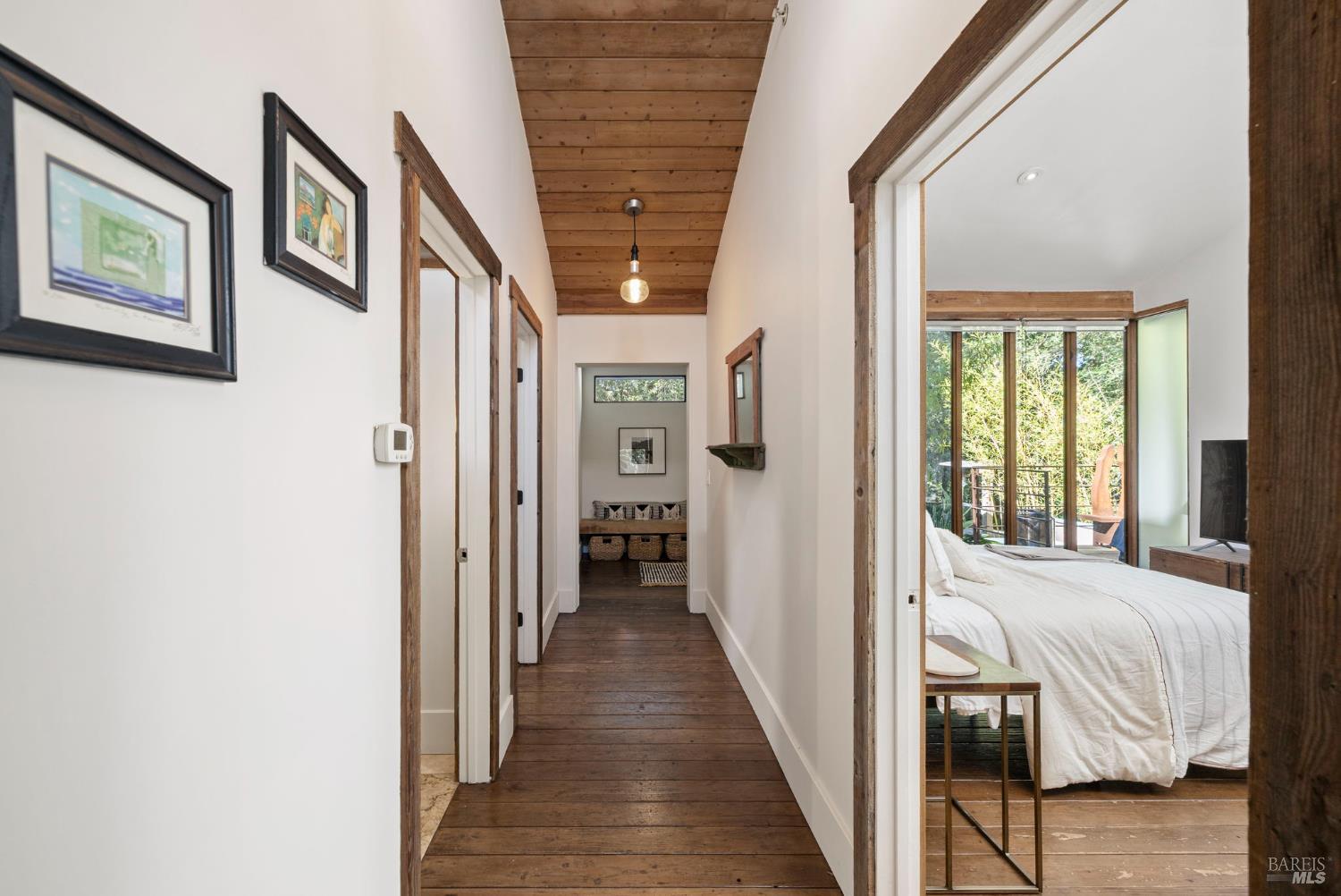 16798 Armstrong Woods Road Guerneville, CA 95446 - Photo 28 of 71 a view of a hallway with wooden floor and windows