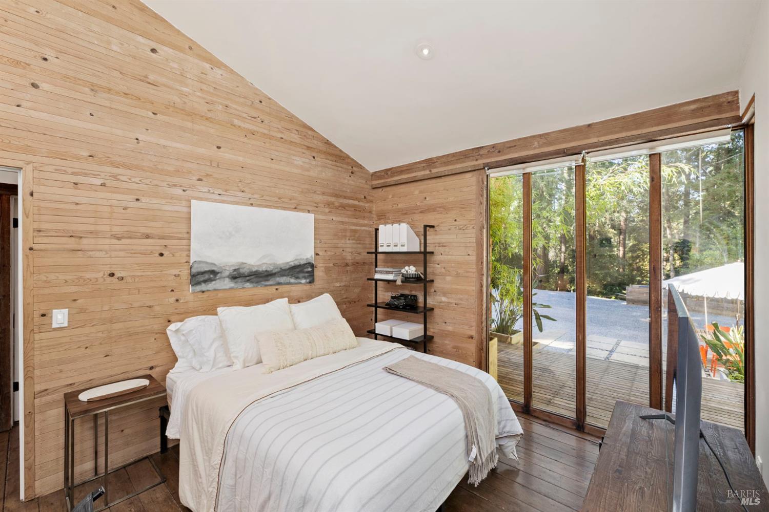 16798 Armstrong Woods Road Guerneville, CA 95446 - Photo 30 of 71 a bedroom with a large bed and a large window