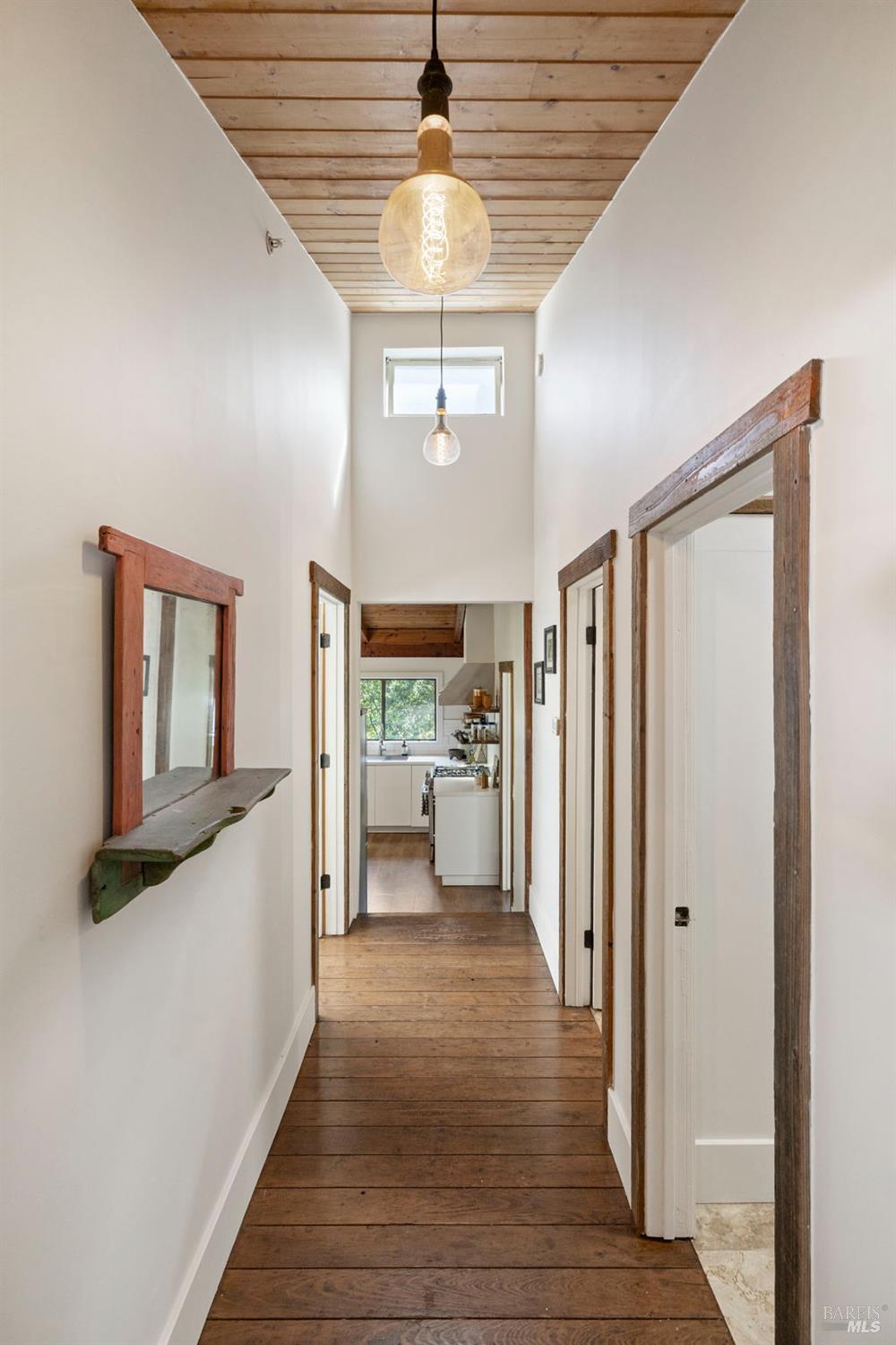 16798 Armstrong Woods Road Guerneville, CA 95446 - Photo 32 of 71 a view of a hallway view with wooden floor and staircase