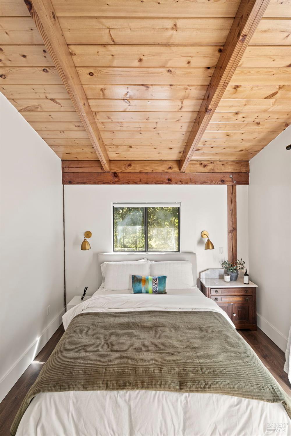 16798 Armstrong Woods Road Guerneville, CA 95446 - Photo 37 of 71 a bedroom with a bed and a chandelier
