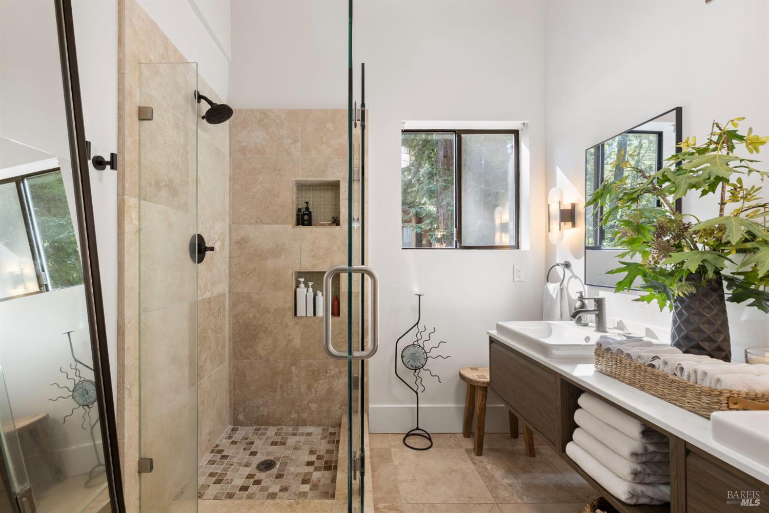 16798 Armstrong Woods Road Guerneville, CA 95446 - Photo 41 of 71 a bathroom with a granite countertop shower a sink and a mirror