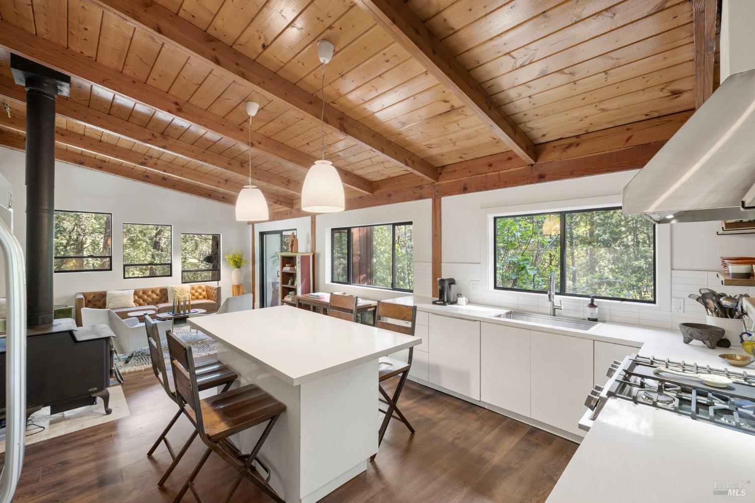 16798 Armstrong Woods Road Guerneville, CA 95446 - Photo 10 of 71 a view of a dining room with furniture large windows and wooden floor