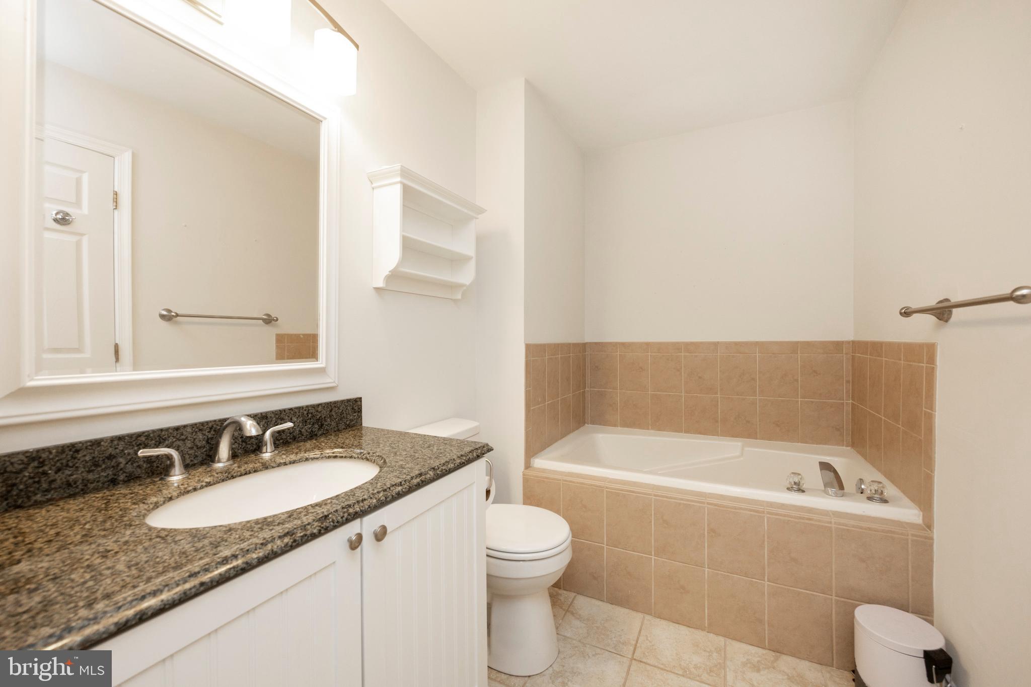 108 Brandywine Road Malvern, PA 19355 - Photo 26 of 35 a bathroom with a granite countertop sink and a bathtub