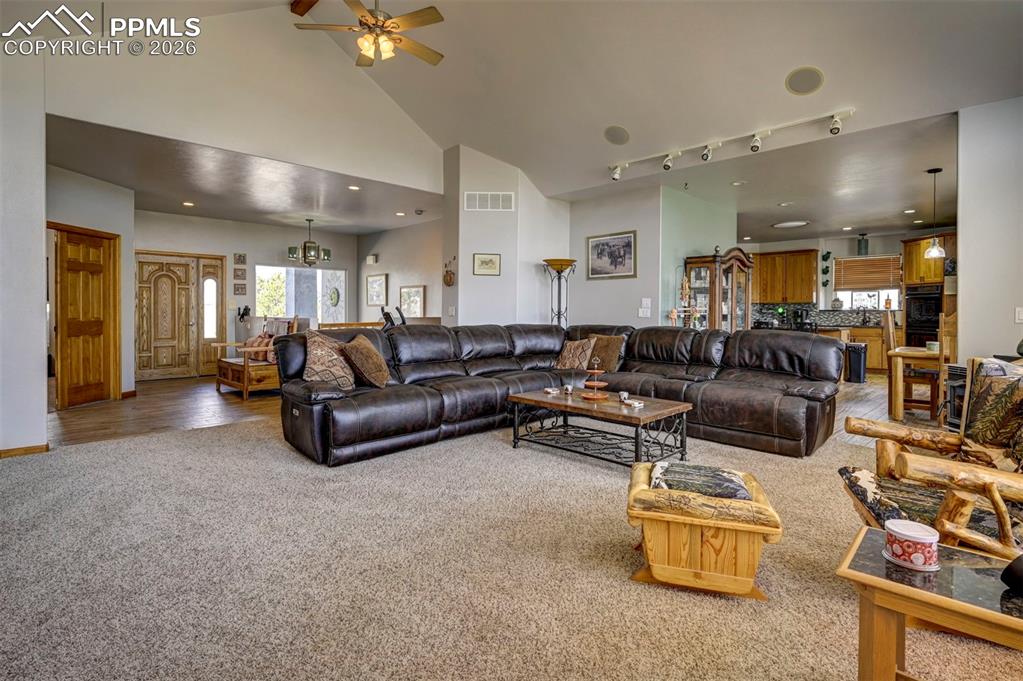 5910 McCart Ranch Circle Elizabeth, CO 80107 - Photo 5 of 50 a living room with furniture and a chandelier