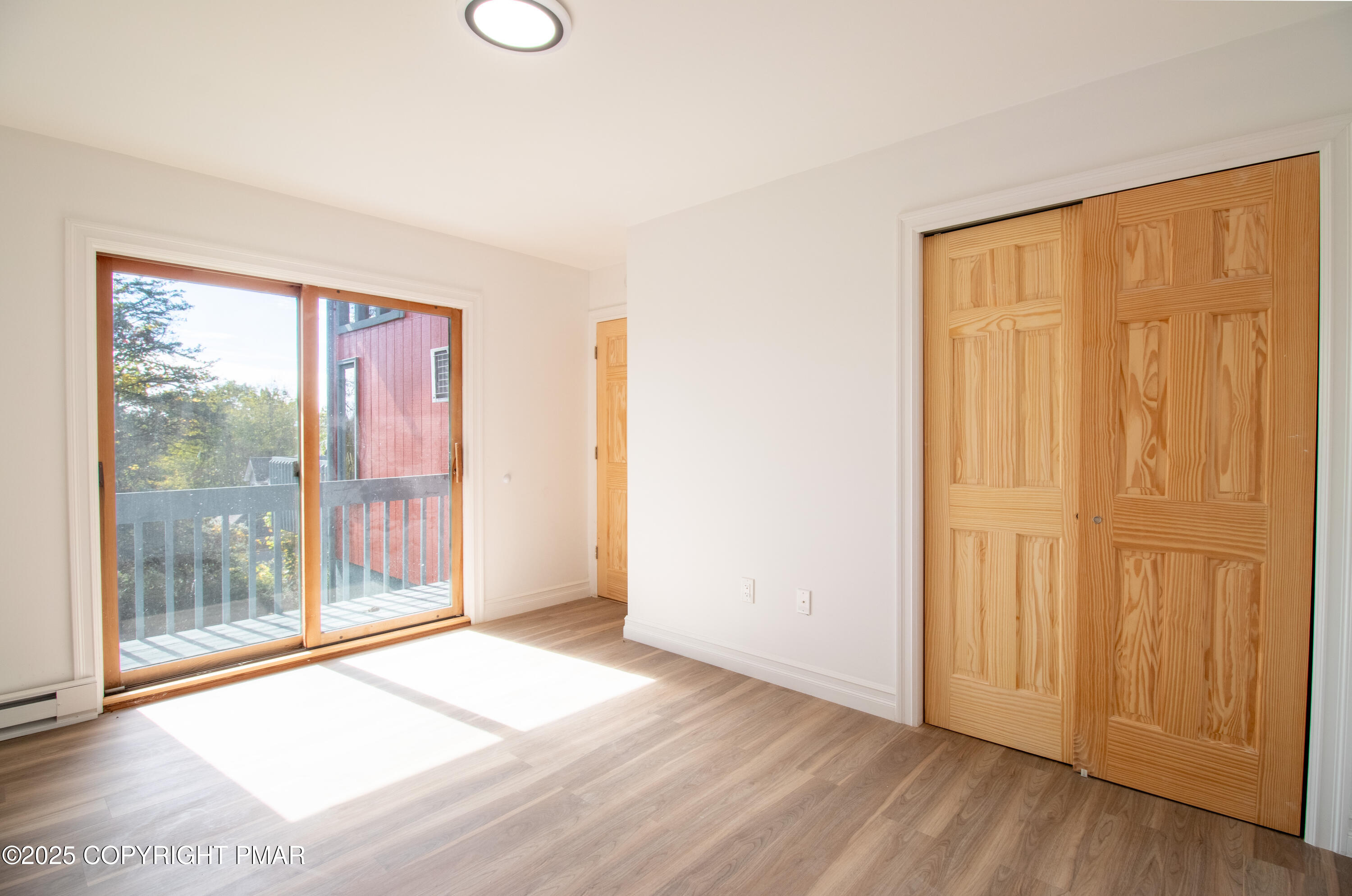 1142 Yorkshire Lane Bushkill, PA 18324 - Photo 15 of 72 a view of an empty room with wooden floor and a window